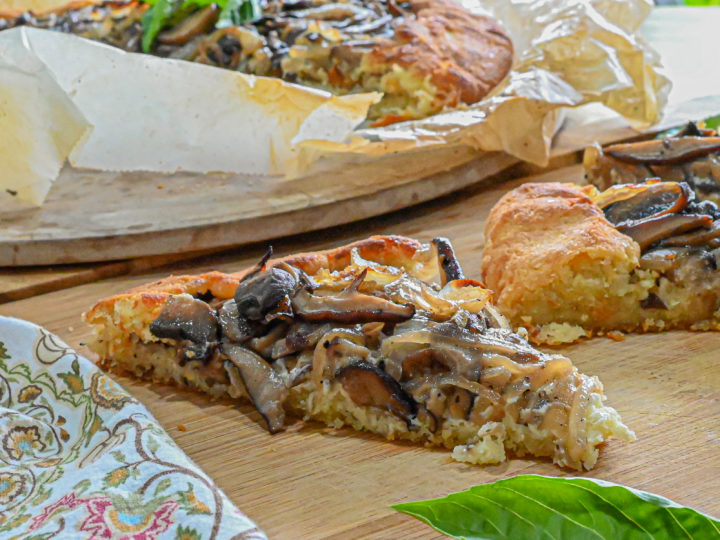 keto mushroom galette slice with more slices and galette in the backgroun