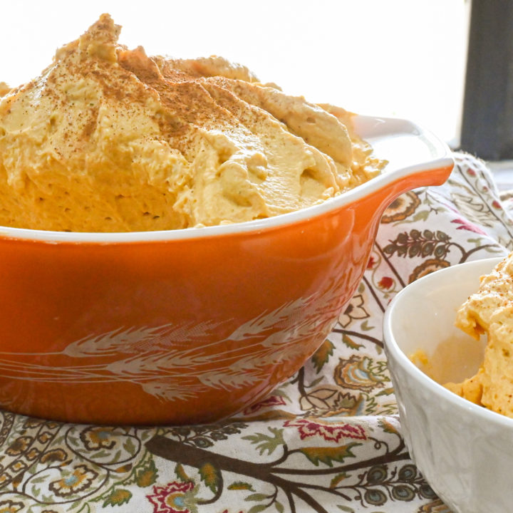 keto pumpkin mousse served in an orange bowl and a small white dish