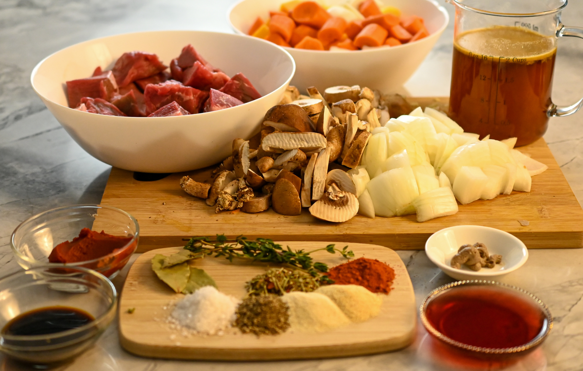 keto beef stew process picture all the ingredients needed displayed on a marble counter