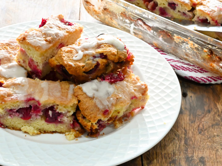 keto cranberry bars stacked on a white plate