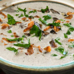 keto cream of mushroom soup with bacon and parsley garnish