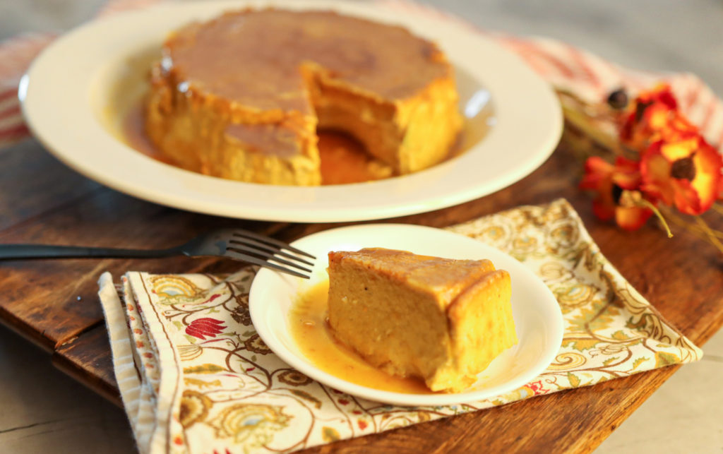 keto pumpkin flan sliced and ready to serve on wood board