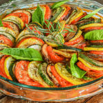 keto ratatouille in clear baking dish topped with fresh herbs