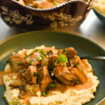 keto ribeye stroganoff served in a teal shallow bowl and a large brown bowl with the stroganoff on the side