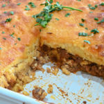 low carb sloppy joe cornbread casserole with a slice missing