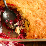 keto cranberry cobbler being served with a black spoon