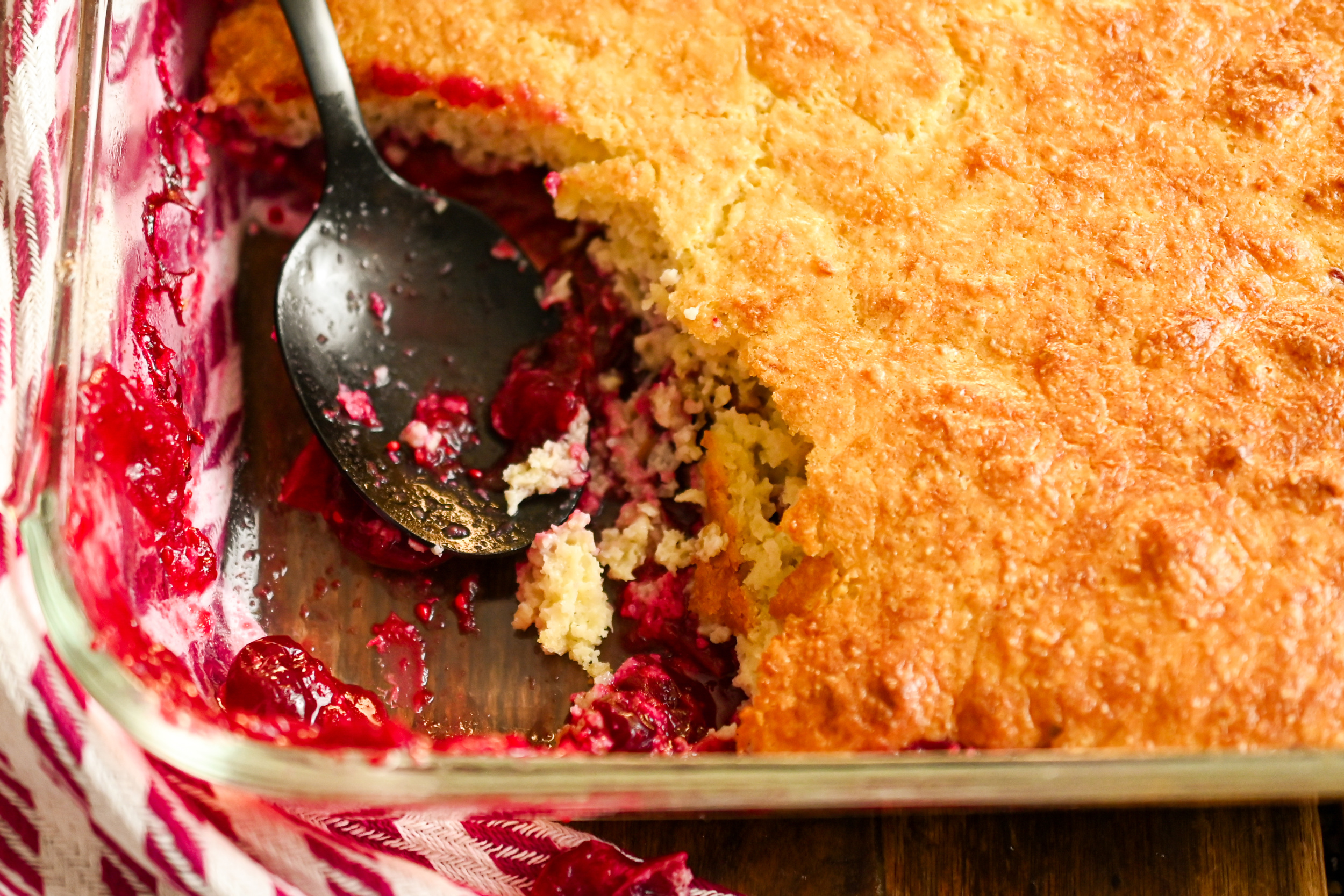 keto cranberry cobbler being served with a black spoon