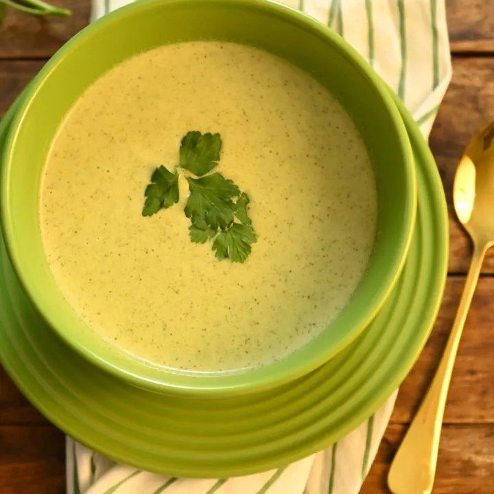 keto cream of broccoli soup served in a green bowl