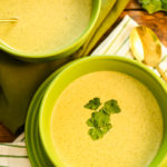 keto cream of broccoli soup served in green bowls
