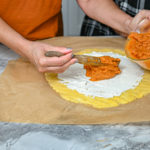 keto savory pumpkin galette being assembled with rolling pin on the side