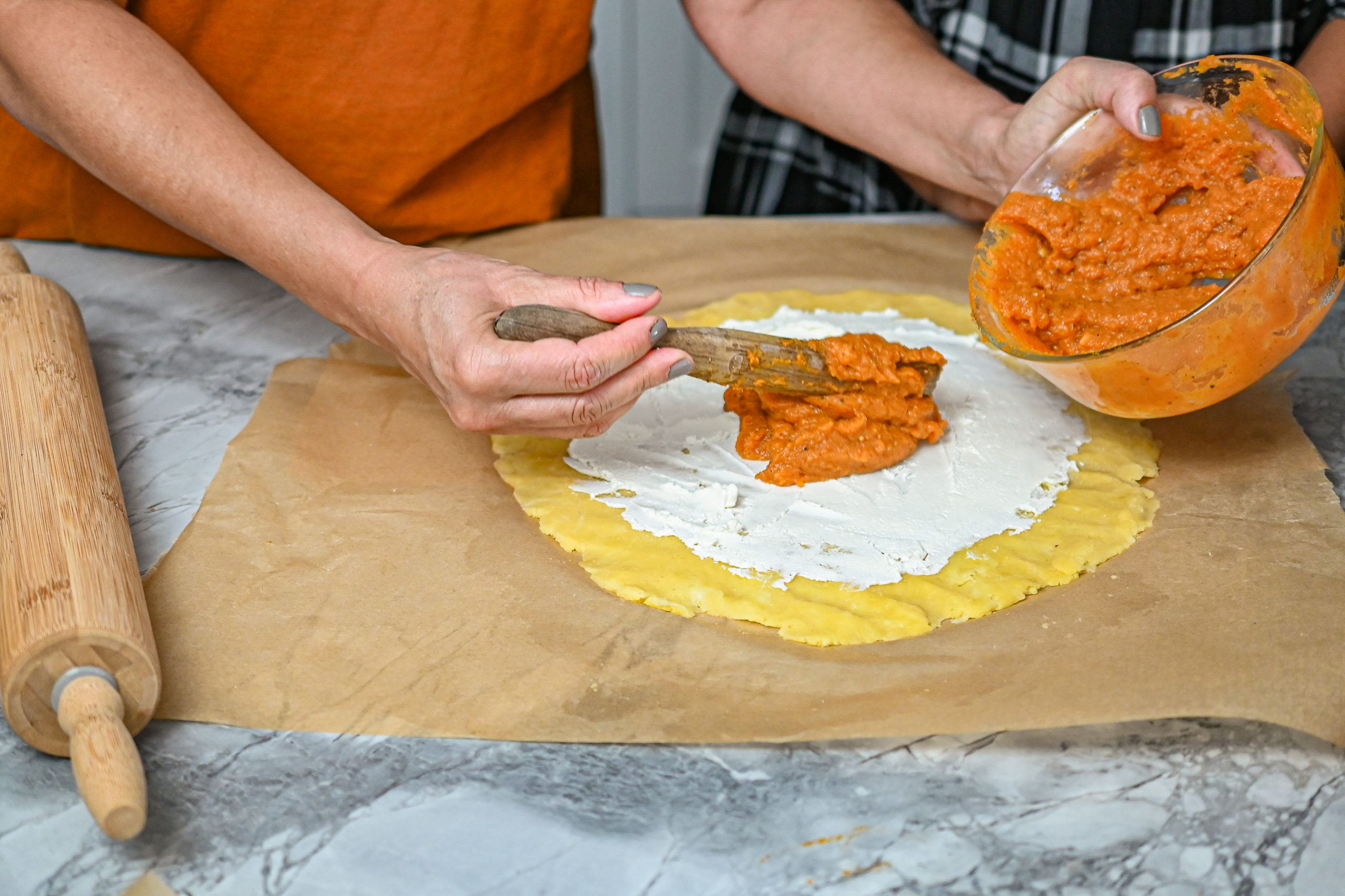 keto savory pumpkin galette being assembled with rolling pin on the side