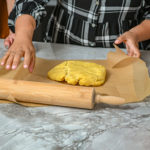 keto savory pumpkin galette crust being worked on coutertop with rolling pin