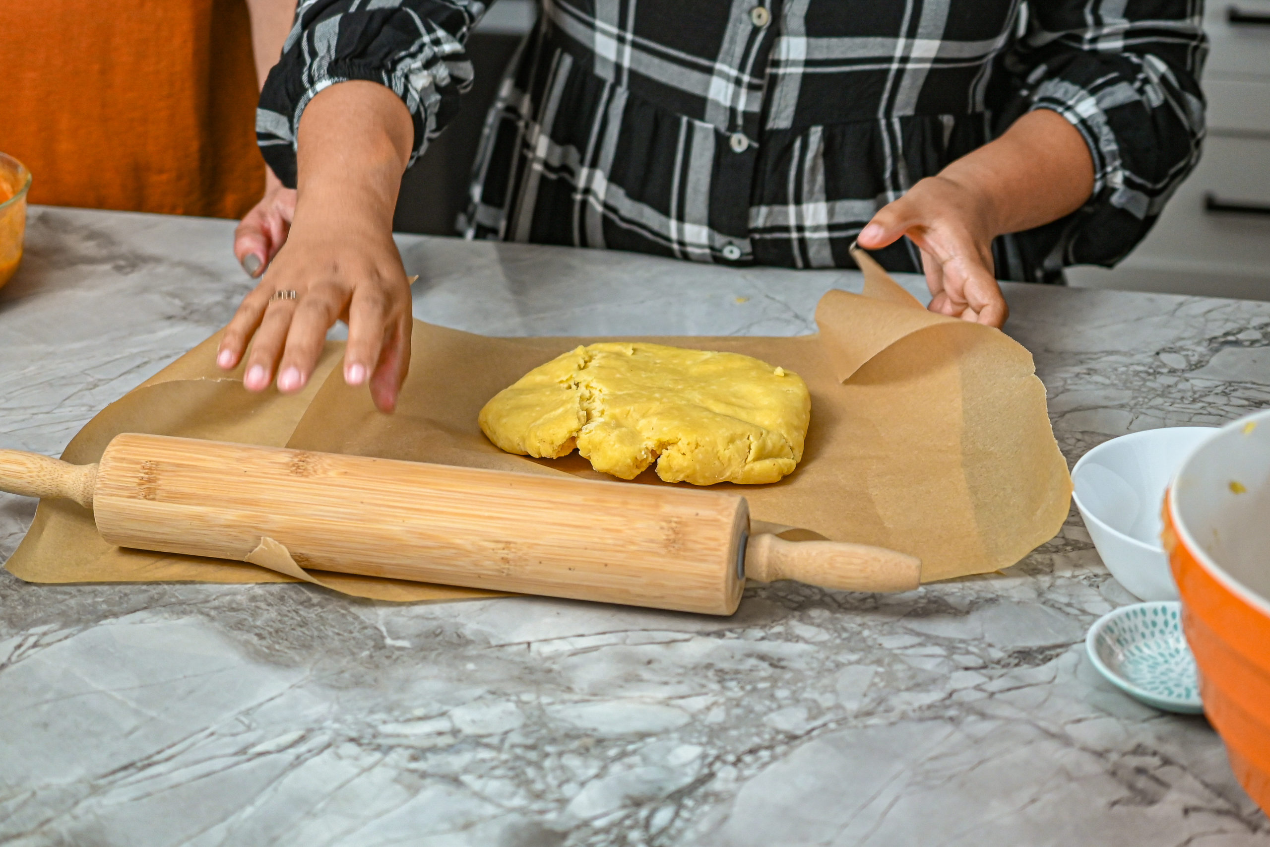 keto savory pumpkin galette crust being worked on coutertop with rolling pin