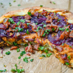 keto savory pumpkin galette on parchment paper with slices removed featured image