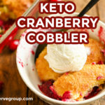 Keto cranberry cobbler served in a small white plate with a scoop of keto vanilla ice cream and a black spoon