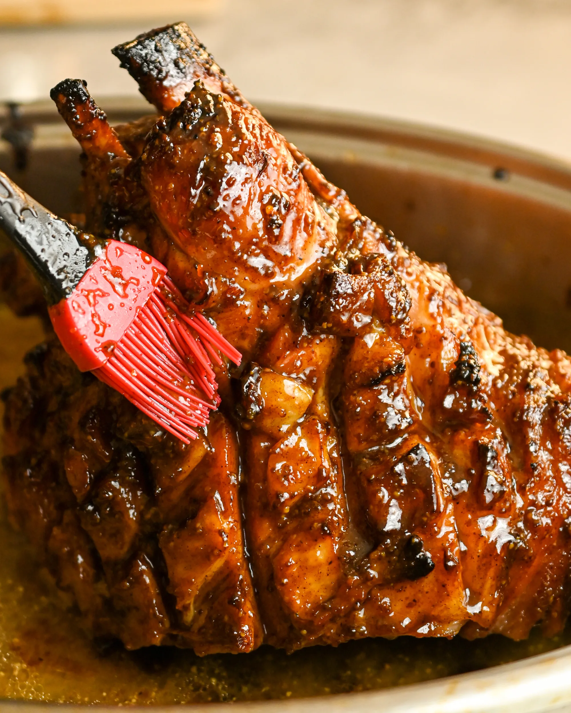 ham being basted with a keto-friendly sweet and spice glazed