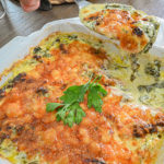 keto creamed spinach in white baking dish being served