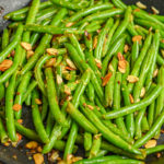 keto green bean almondine being sauteed in large skillet
