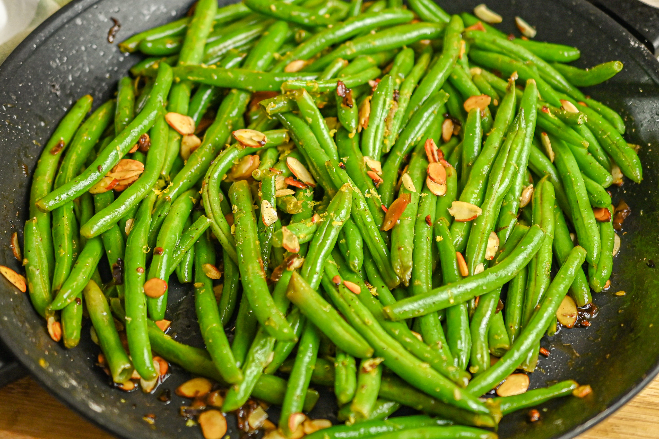 keto green bean almondine being sauteed in large skillet