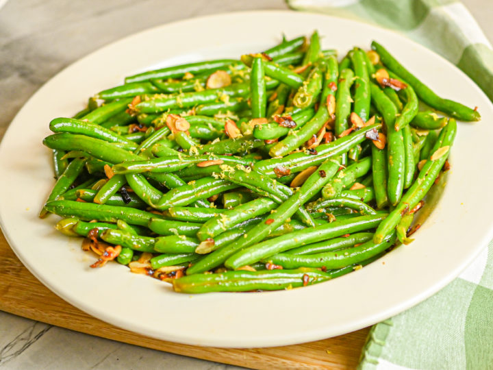 keto green bean almondine served in white dish white green and white towel featured image