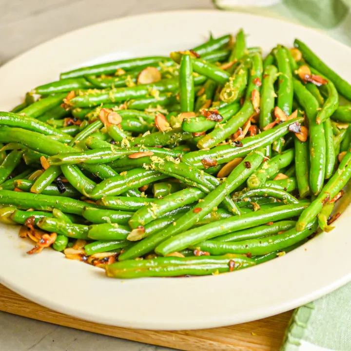 keto green bean almondine served in white dish white green and white towel featured image