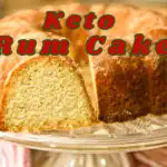 keto rum cake on a clear cake stand