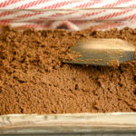 keto gingerbread cake being spread into a rectangle container