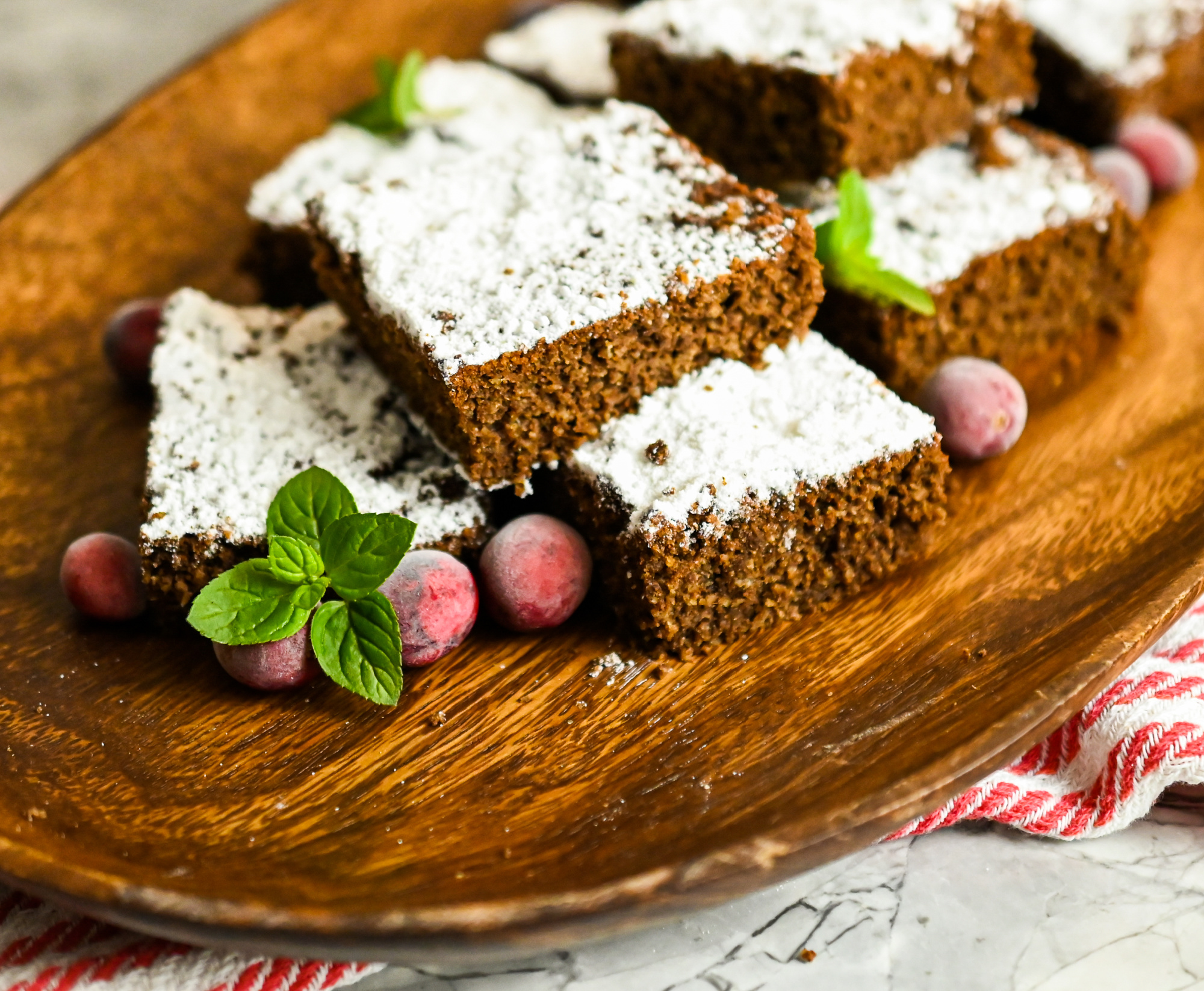 keto gingerbread snack cake sliced on a wood board