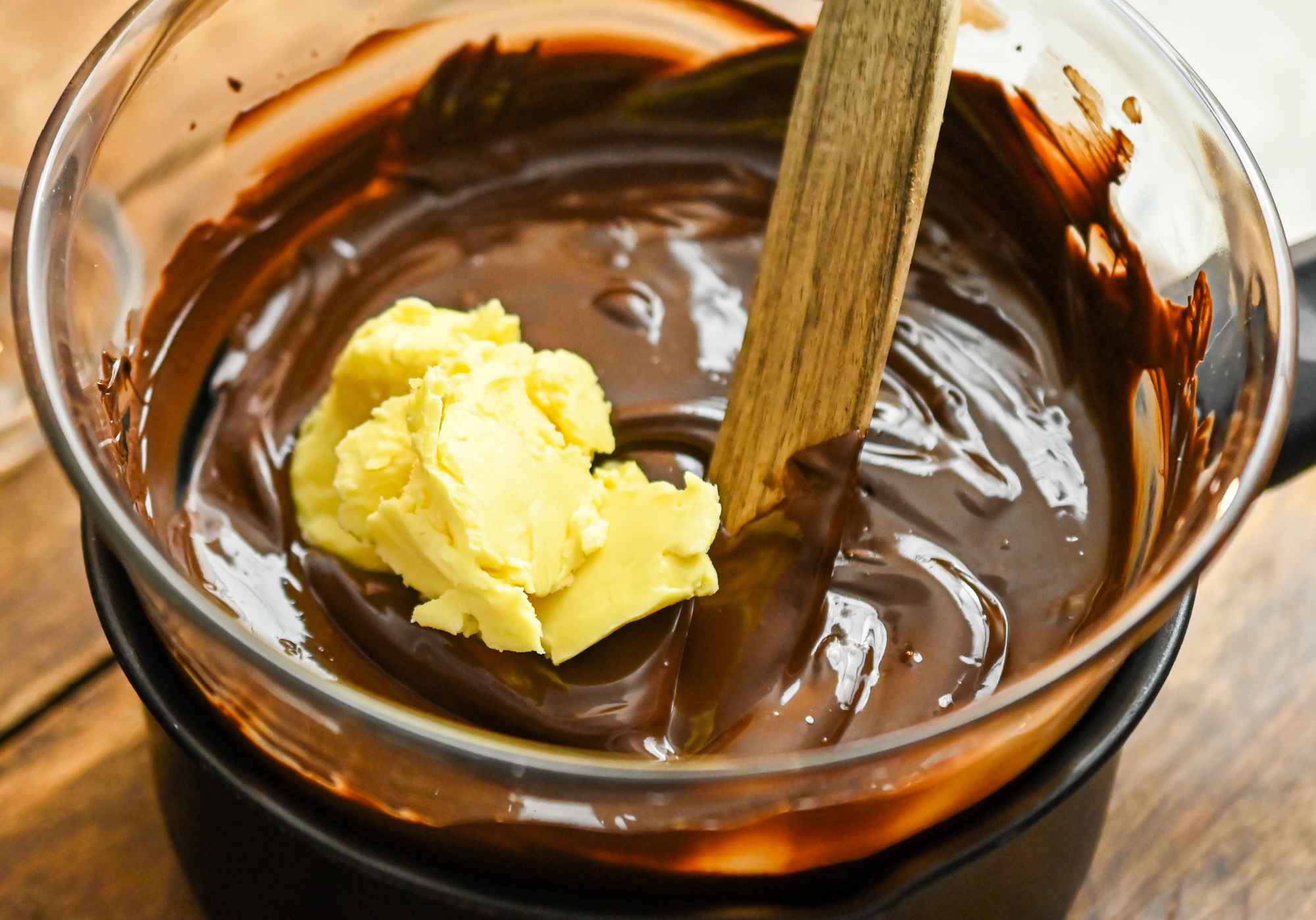 palm shortening being melted with sugar free chocolate chips in a double boiler