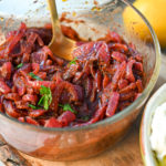 Keto sumac onion spread in a clear round bowl