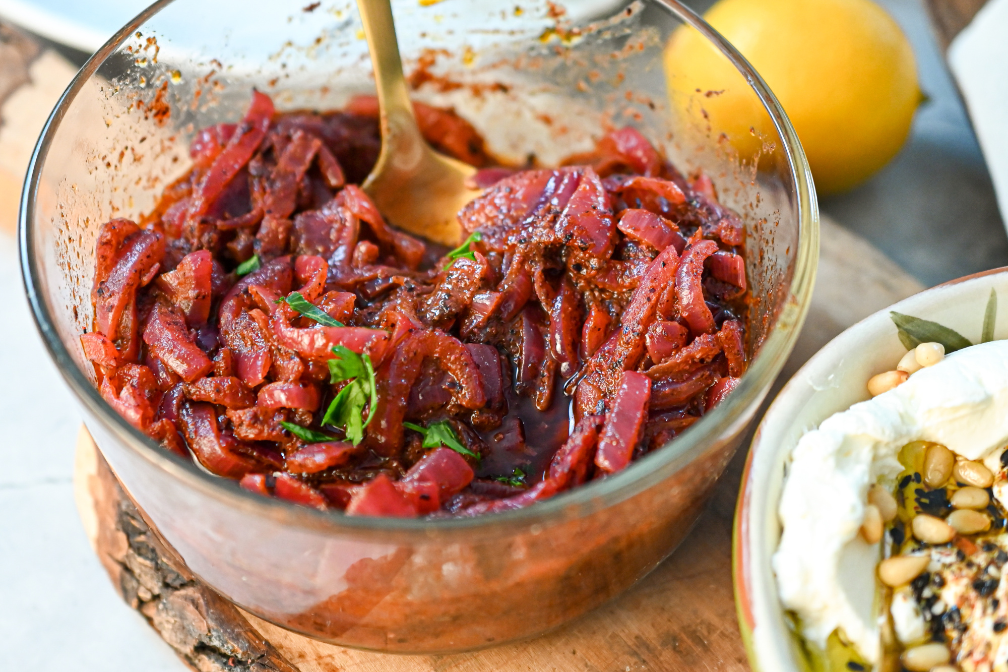 Keto sumac onion spread in a clear round bowl