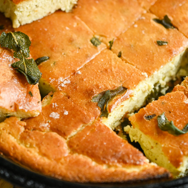 keto brown butter sage cornbread sliced in a cast-iron skillet