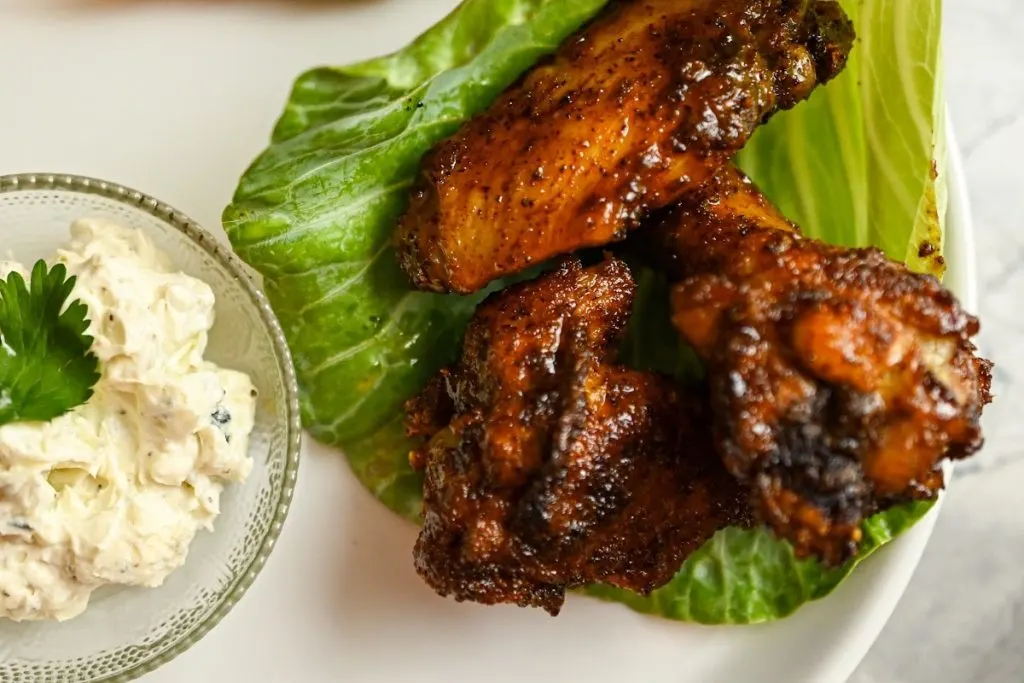 keto chipotle sweet and spicy baked wings with a side of blue cheese sauce