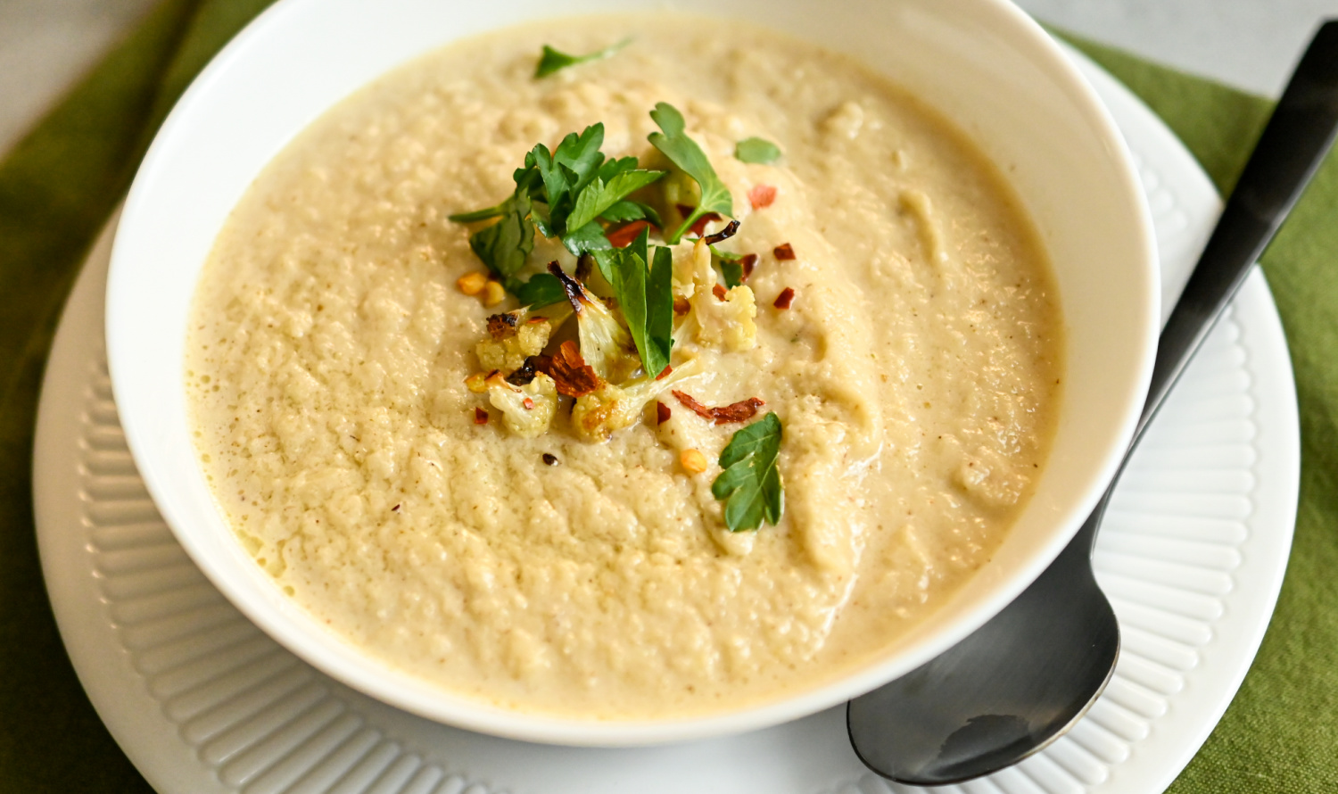 keto roasted cauliflower soup in a white bowl
