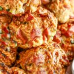 keto sausage balls with a small dish white dish of cilantro jalapeño sauce