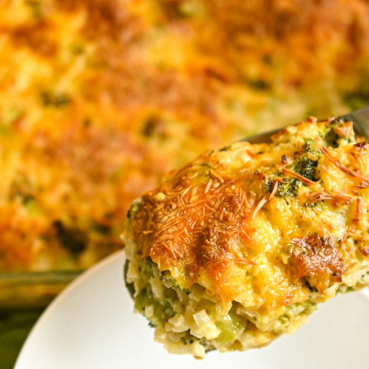 keto broccoli cauliflower rice casserole being served into a white bowl