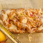 keto raspberry bread with lemon being zested on top