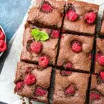 keto raspberry brownies sliced on parchment paper