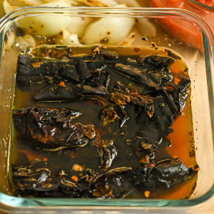 roasted peppers soaking in preparation for the enchilada sauce recipe