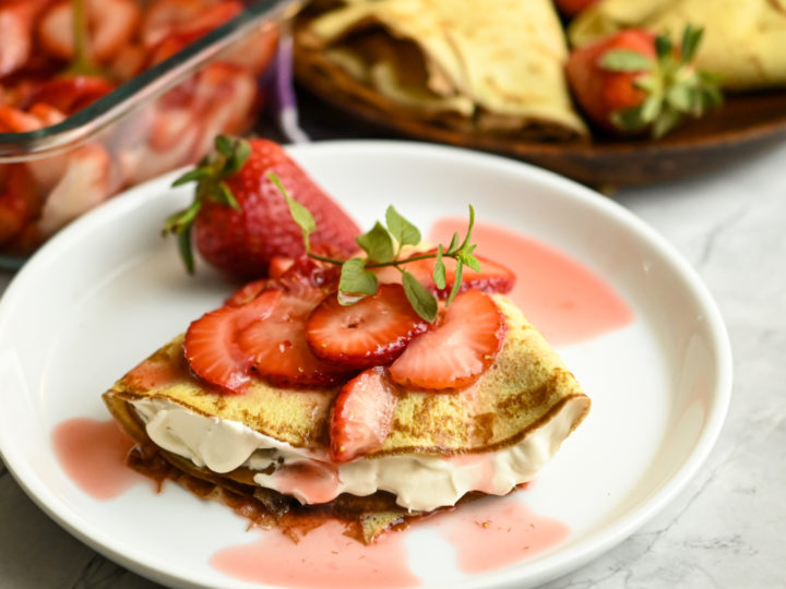 Crepini strawberry cream cheese crepe served on a white plate