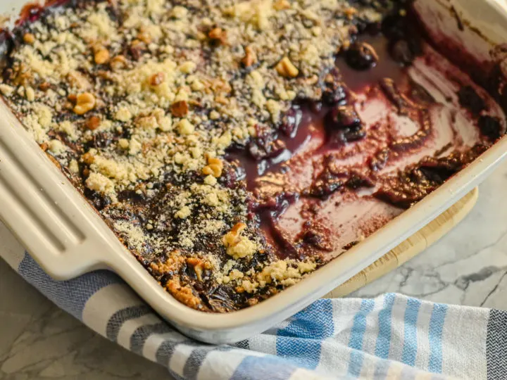 keto blueberry crisp in white baking dish