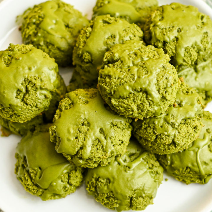 keto matcha coconut flour cookies stacked on a white plate