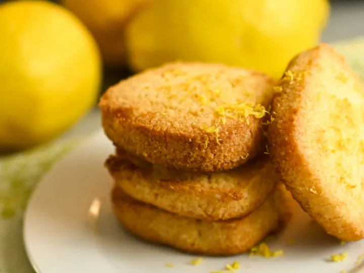 low carb lemon shortbread square cookies stacked on a white plate