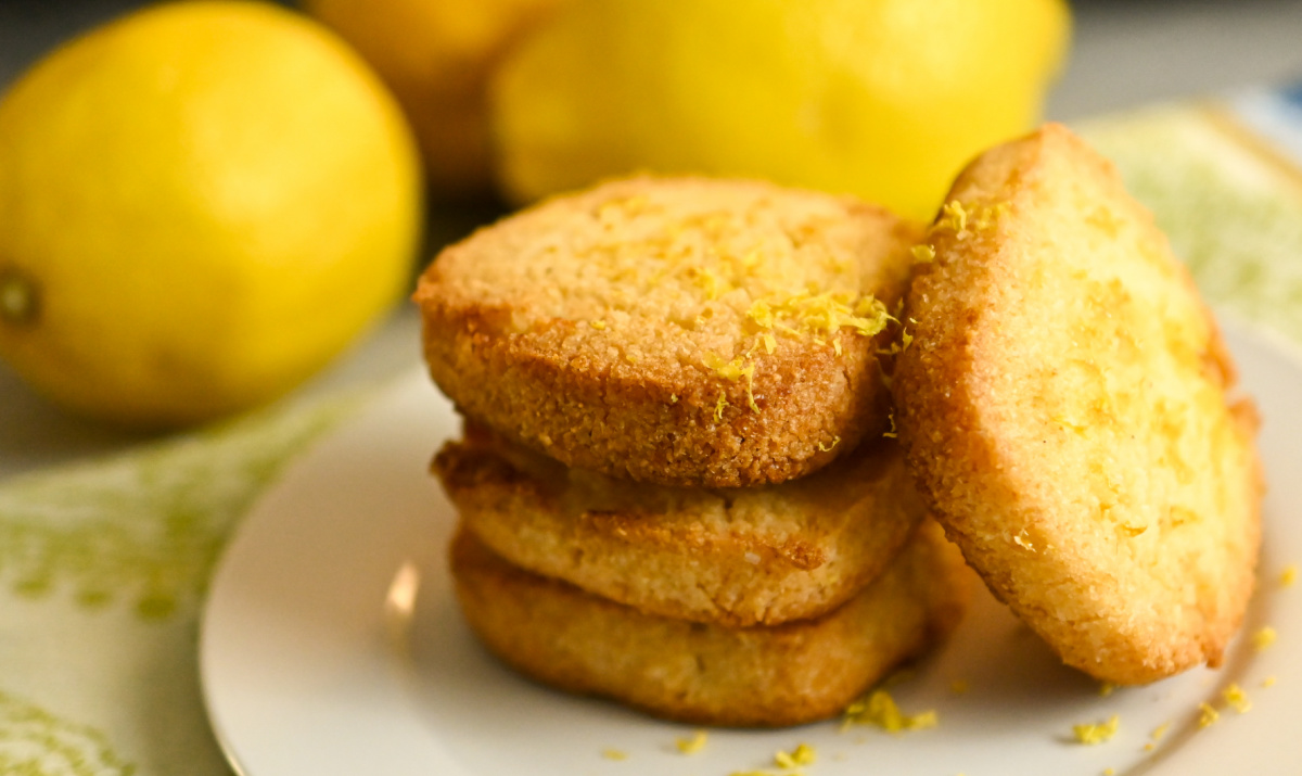 low carb lemon shortbread square cookies stacked on a white plate