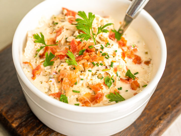 keto chicken bacon chowder served in a small white bowl on a wood board