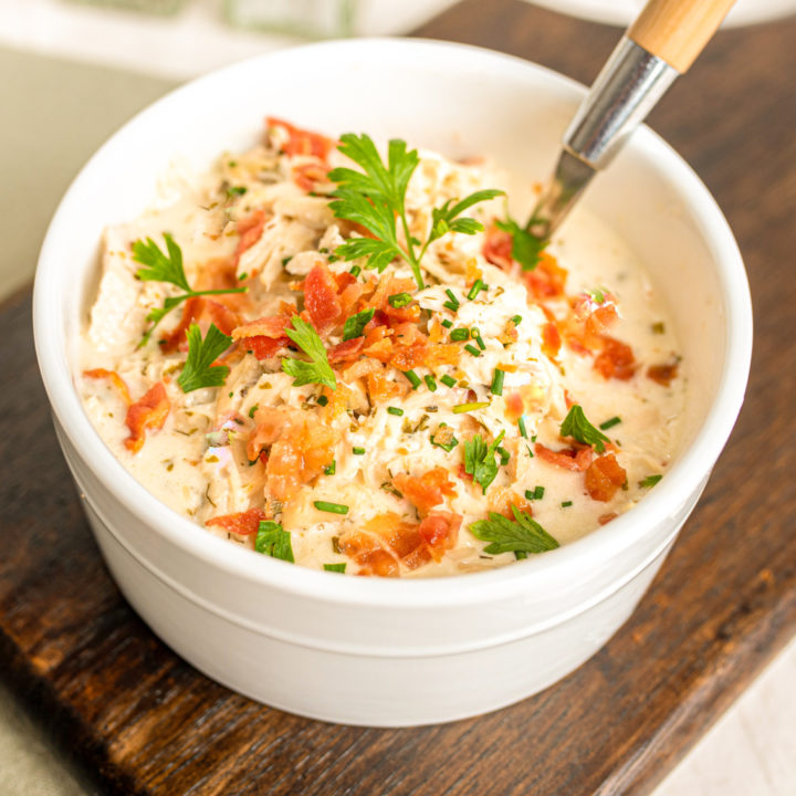 keto chicken bacon chowder served in a small white bowl on a wood board