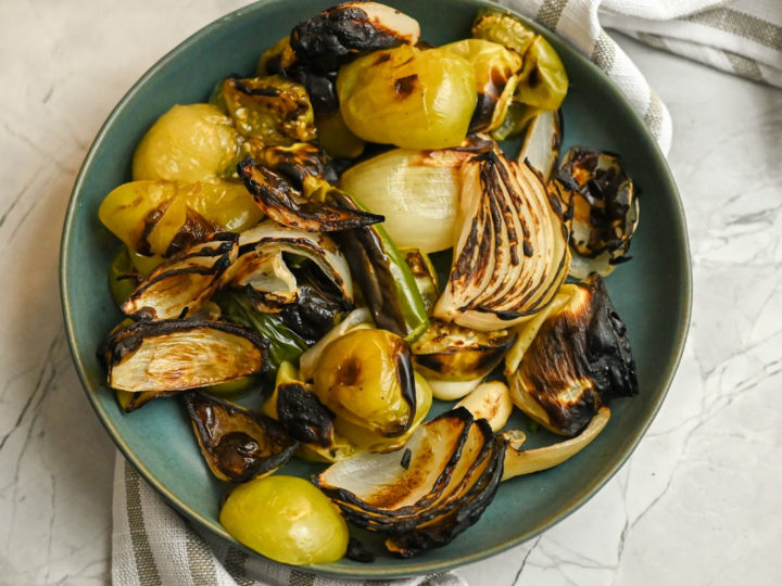 roasted vegetables for green enchilada sauce in a green plate