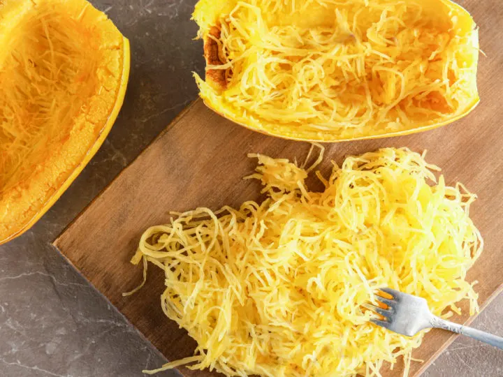 spaghetti squash sliced with a fork making it into strands
