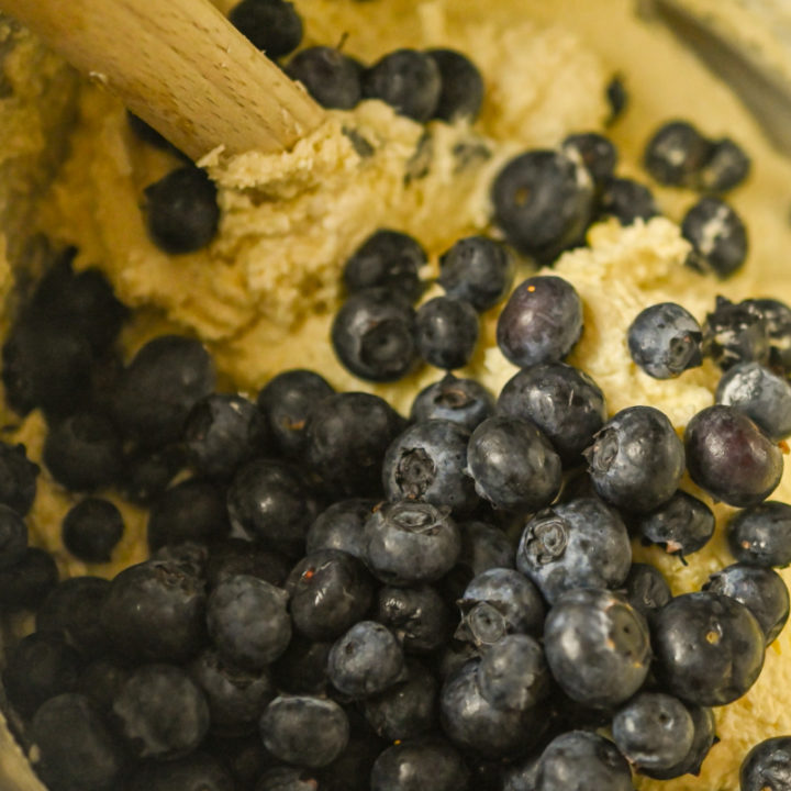 blueberries folded into a keto cake batter