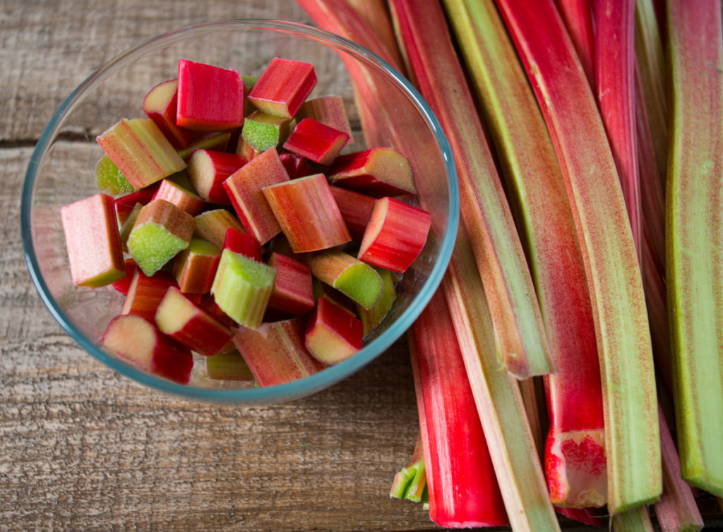 fresh rhubarb on a wooden board